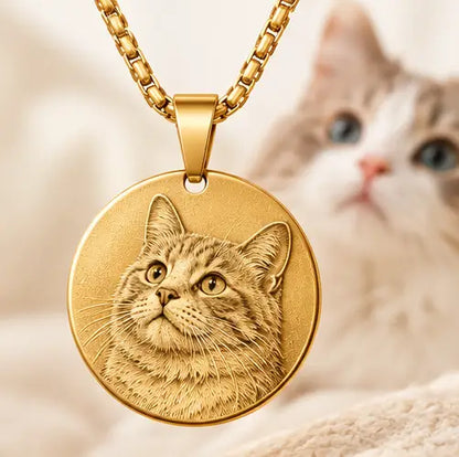Gold personalized cat portrait necklace with an engraved round pendant and a cat in the background